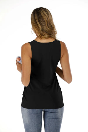 Woman wearing a black sleeveless top and blue jeans on a white background