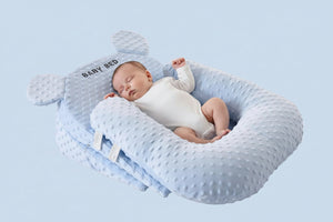 Baby bed with U-shaped pillow and 15-degree pad in ocean blue color on a light gray background.