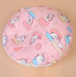 Pink bean bag with cartoon character pattern on a beige background