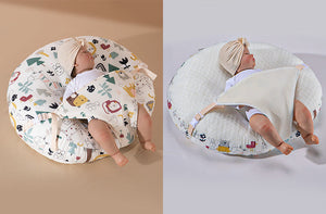 A newborn lounger pillow with a printed design, featuring a baby lying on it in a supine position.