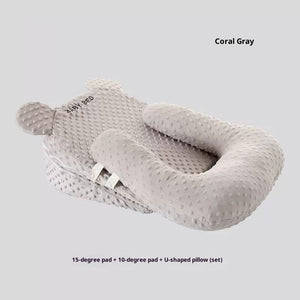 Gray baby support pillow set on a light gray background