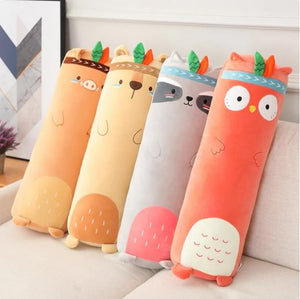 Four animal-shaped cushions on a couch with a neutral background