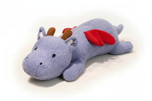 Plush dragon toy on a textured surface with a blurred indoor background