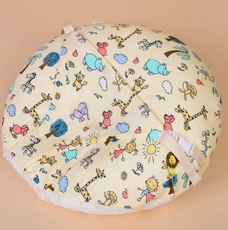 Baby play mat with colorful animal patterns on a beige background