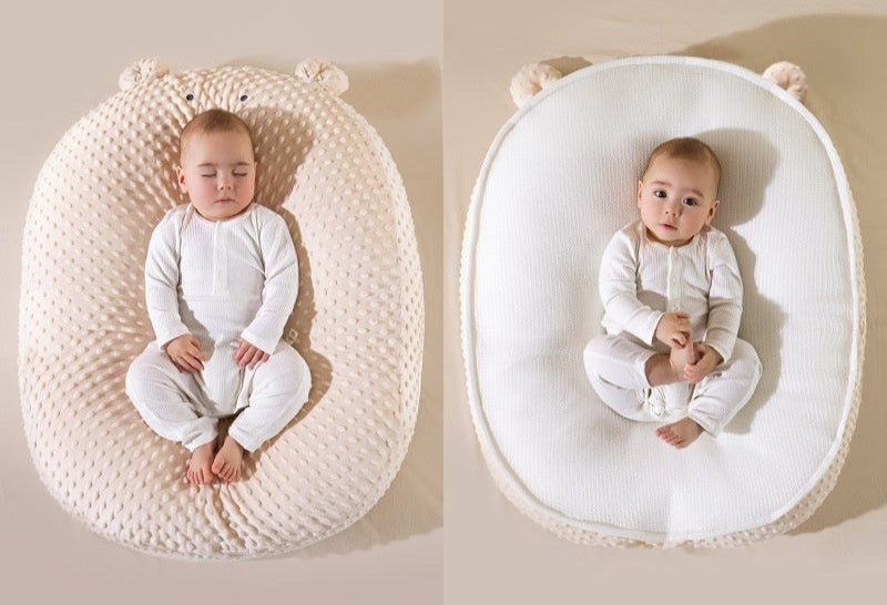 Baby in a double-sided Doudou Bear pillow with text indicating different materials on each side.