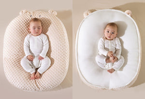 Baby in a double-sided Doudou Bear pillow with text indicating different materials on each side.