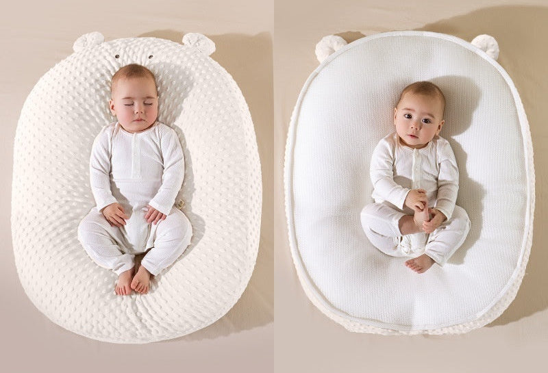 Baby in a double-sided baby nest with different textures on each side.
