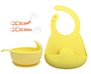 Yellow baby bowl, bib, and spoons on a white background