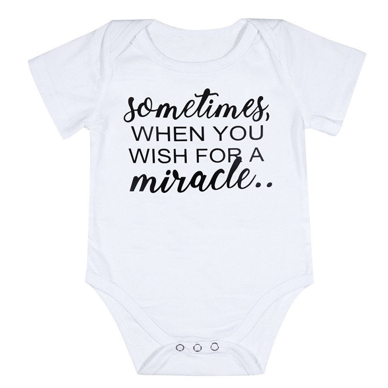 White baby onesie with black text on a white background