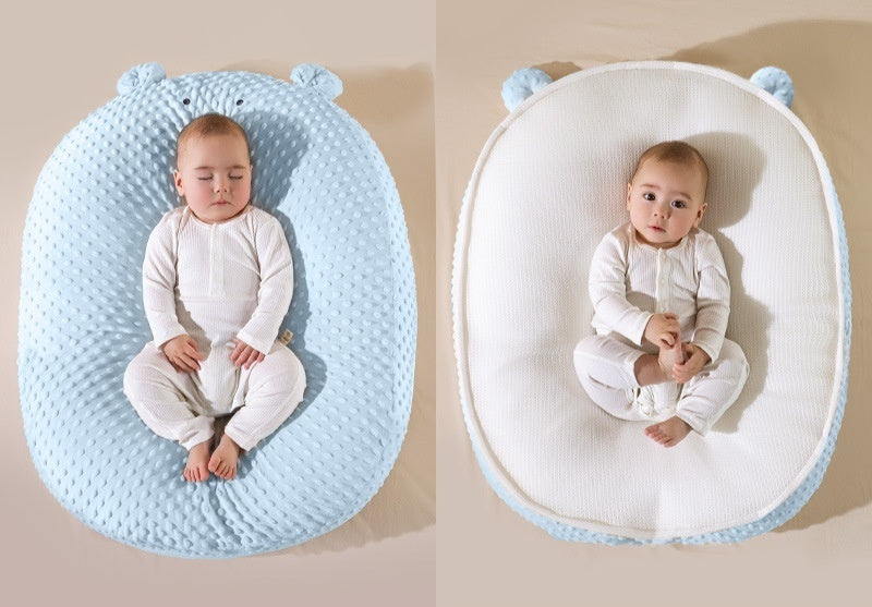 Baby lying on a blue and white Doudou Bear double-sided cushion with text indicating different fabric types.