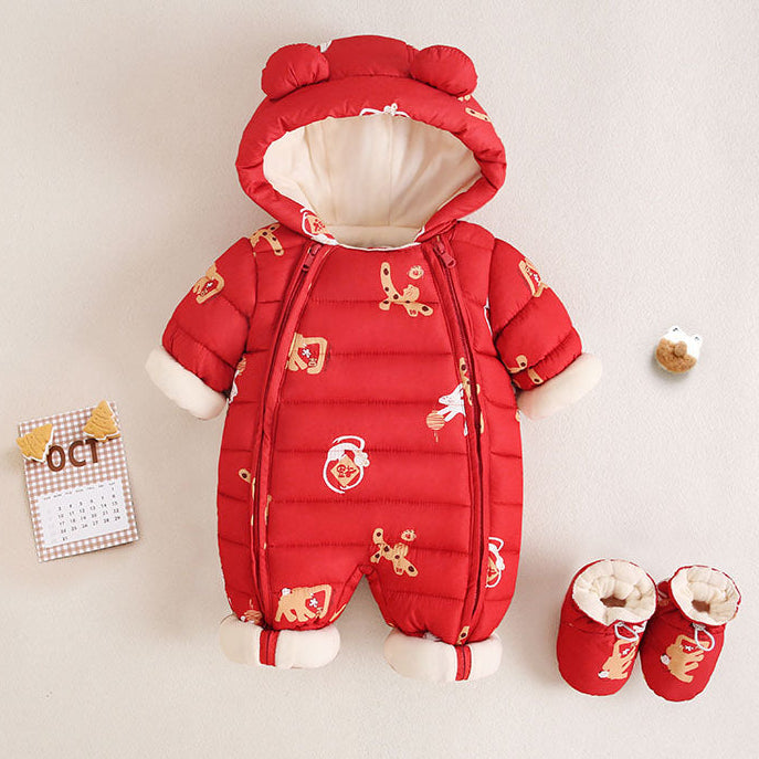 Red baby snowsuit with white accents and gold patterns on a beige background