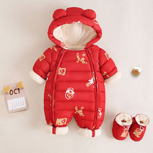 Red baby snowsuit with white accents and gold patterns on a beige background