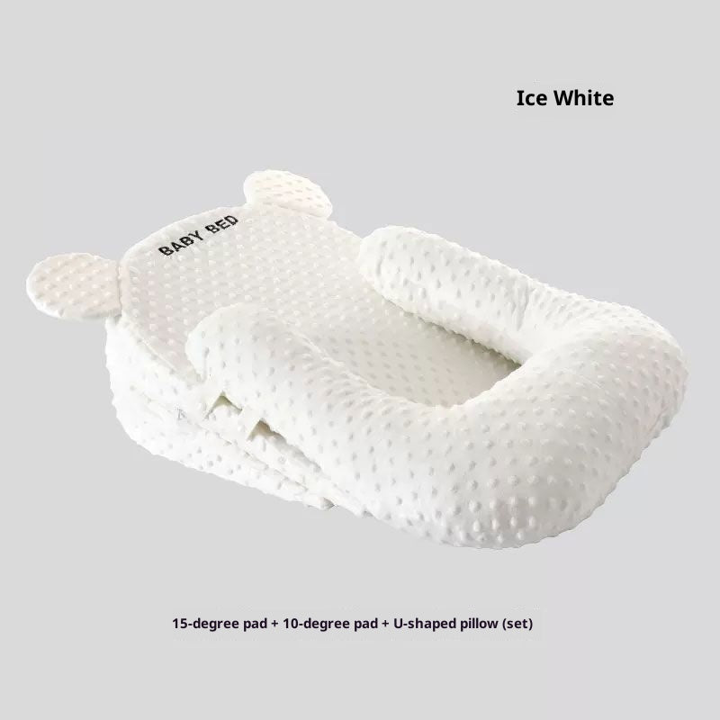 White baby pillow set with U-shaped design on a light gray background