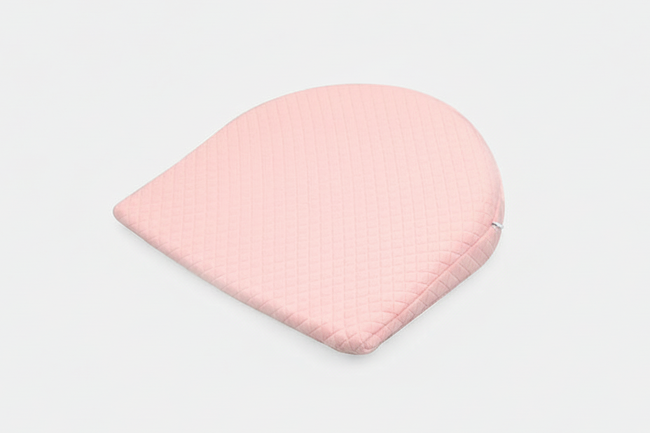 Pink baby hat on a light gray background