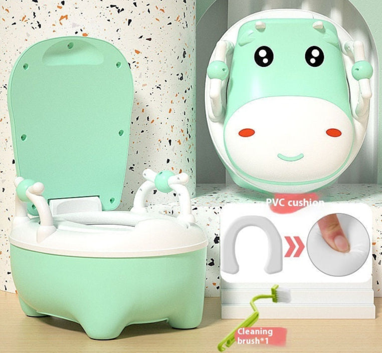 Two cow-themed potty chairs for toddlers, one in pink and one in blue, each with a soft seat cover and a closed lid.