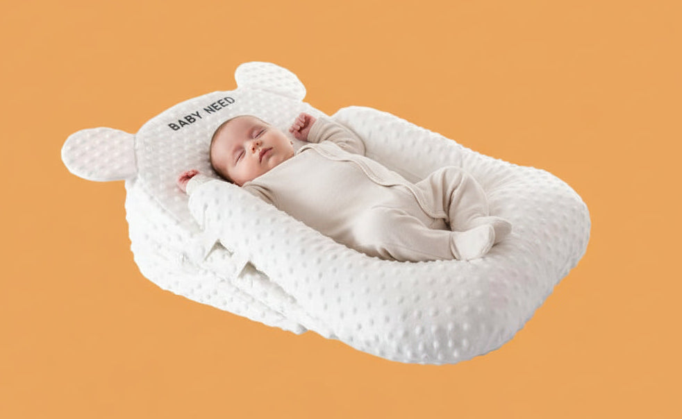 Baby bed with U-shaped pillow and 15-degree pad on a light gray background