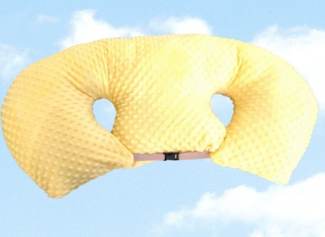 Yellow U-shaped pillow against a blue sky background