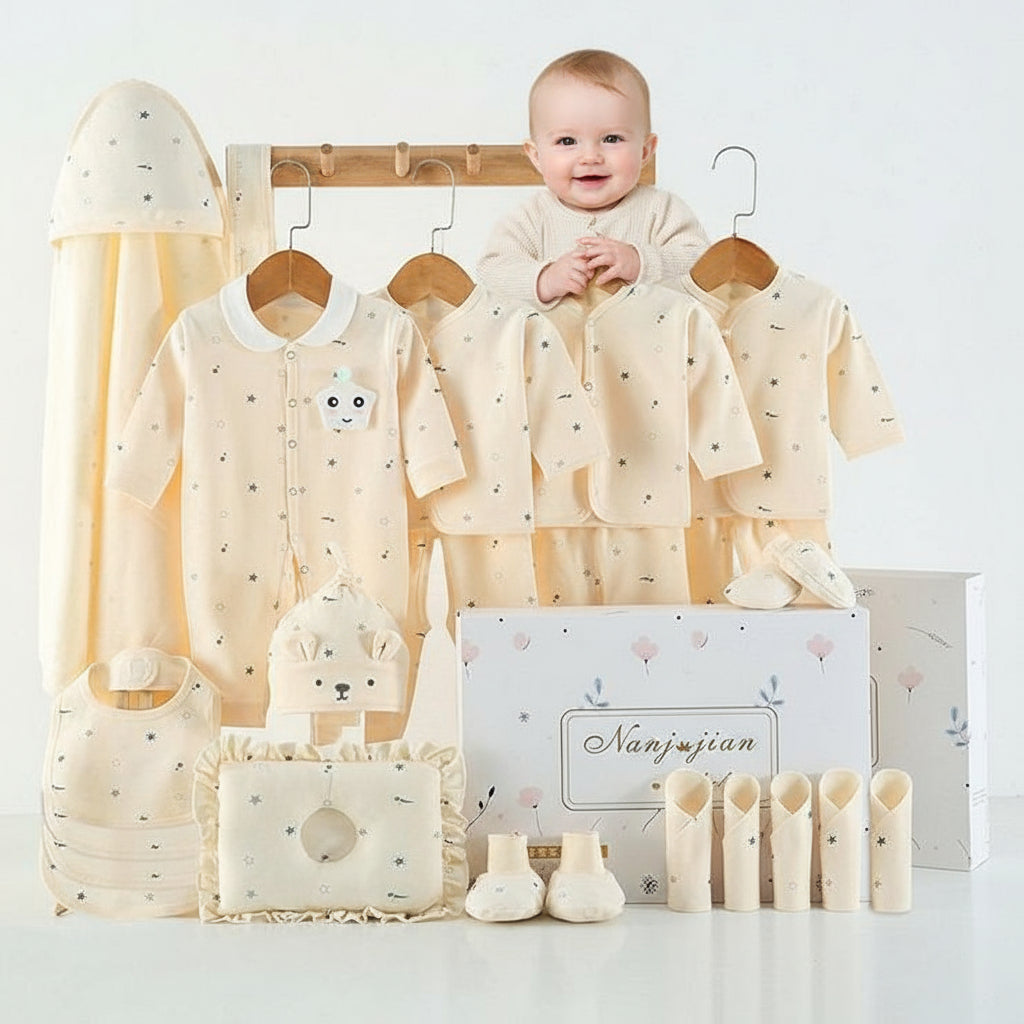 Baby clothing set with shirts, pants, and accessories on a white background