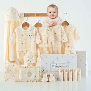 Baby clothing set with shirts, pants, and accessories on a white background