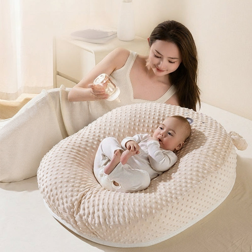 Woman feeding a baby with a bottle on a textured cushion
