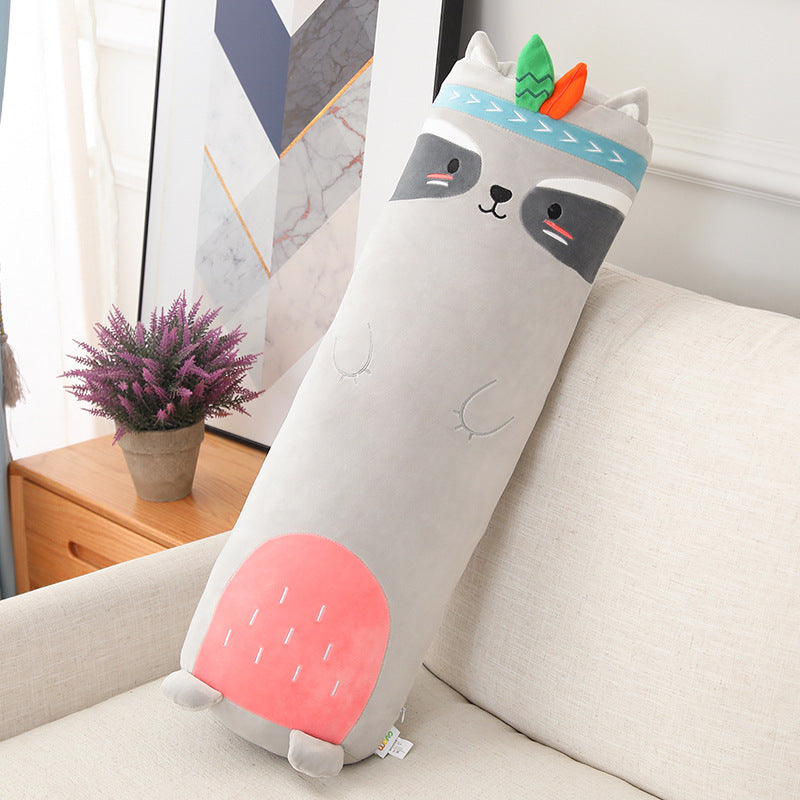 Cylindrical pillow with cartoon face design on a couch