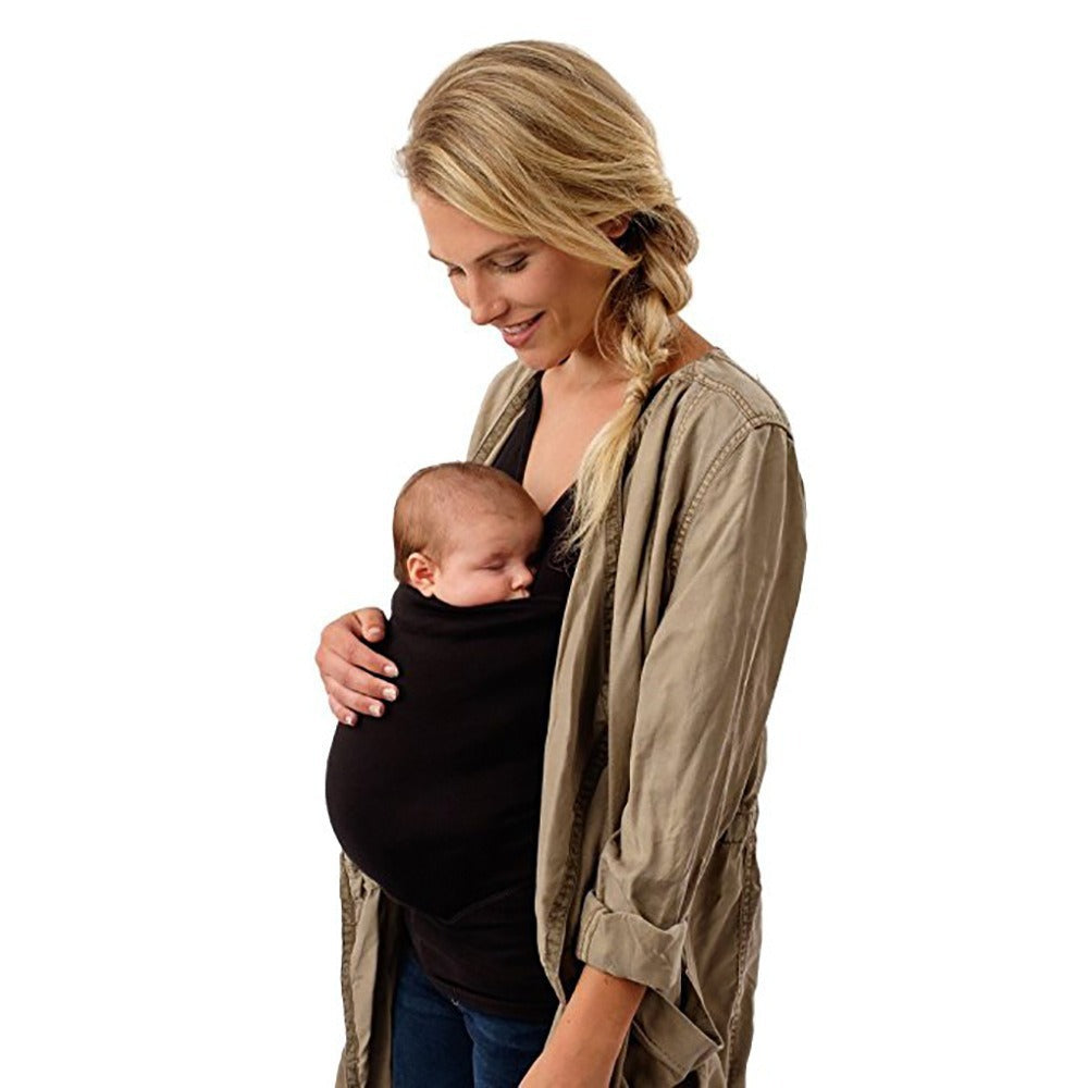 Woman holding a baby in a sling against a white background
