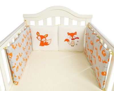 Crib with fox-themed bedding set on a white background