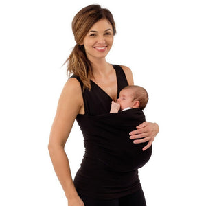 Woman holding a baby in a black sling against a white background