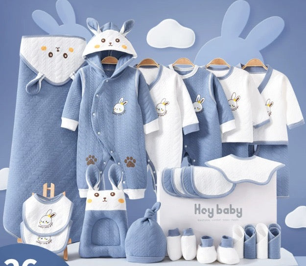 Collection of baby clothing and accessories with cartoon rabbit design on a blue background.