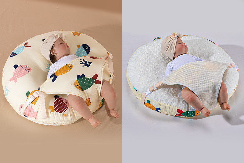 A newborn lounger pillow with a printed design, featuring a baby lying on it in a supine position.