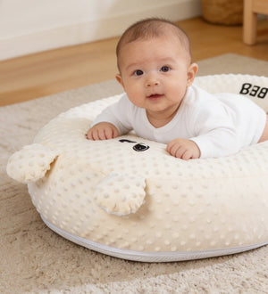 Baby lying on a tummy time pillow with text about its benefits