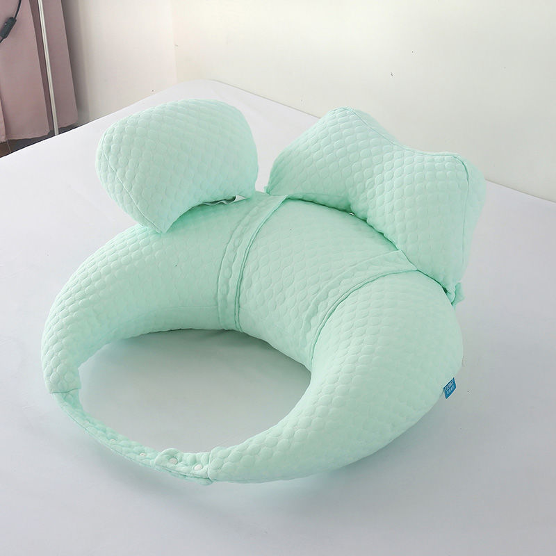 Mint green U-shaped pillow on a white surface