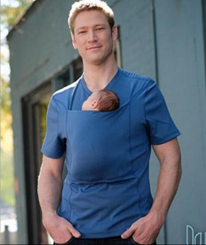 Man wearing a blue baby carrier outdoors