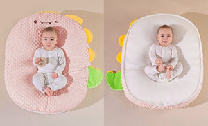 Baby nest with dinosaur design in pink and white on a beige background