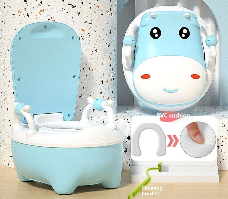 Two cow-themed potty chairs for toddlers, one in pink and one in blue, each with a soft seat cover and a closed lid.