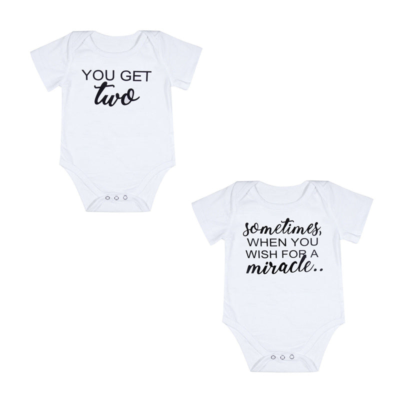 Two white baby onesies with black text on a white background