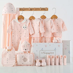 Baby clothing set with pink outfits, accessories, and a canopy on a white background.