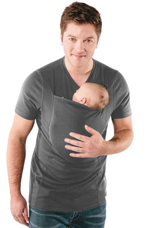 Man holding a baby in a sling against a white background