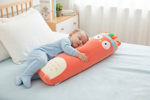 Cute orange plush toy shaped like a cartoon character on a couch