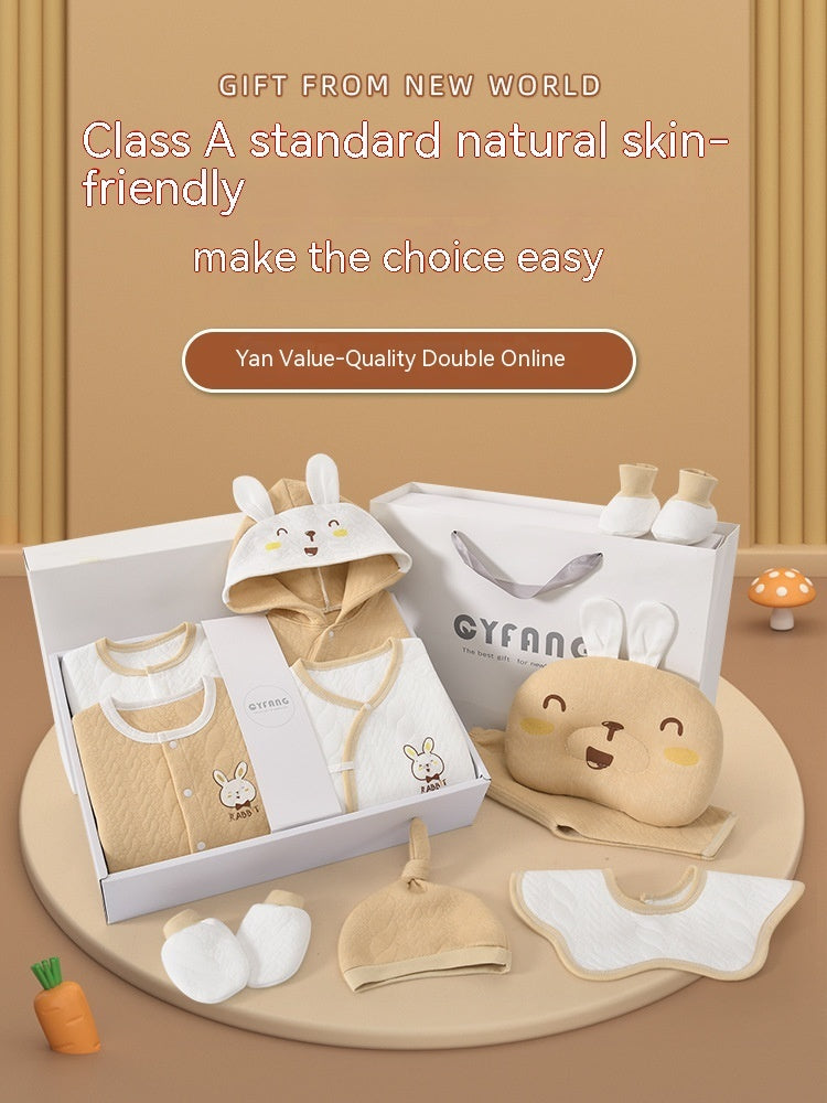 Baby clothing set with accessories on a wooden surface, featuring text about natural skin-friendly products.