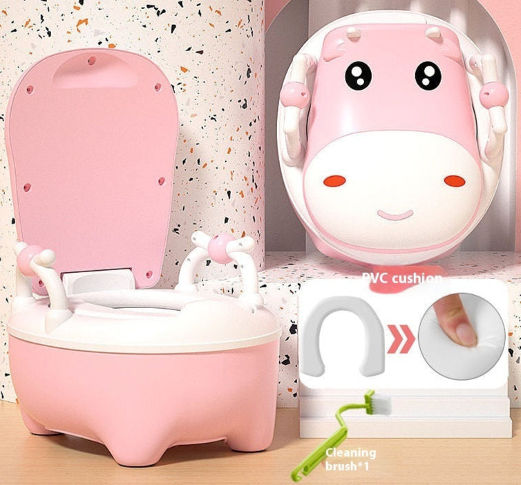 Two cow-themed potty chairs for toddlers, one in pink and one in blue, each with a soft seat cover and a closed lid.