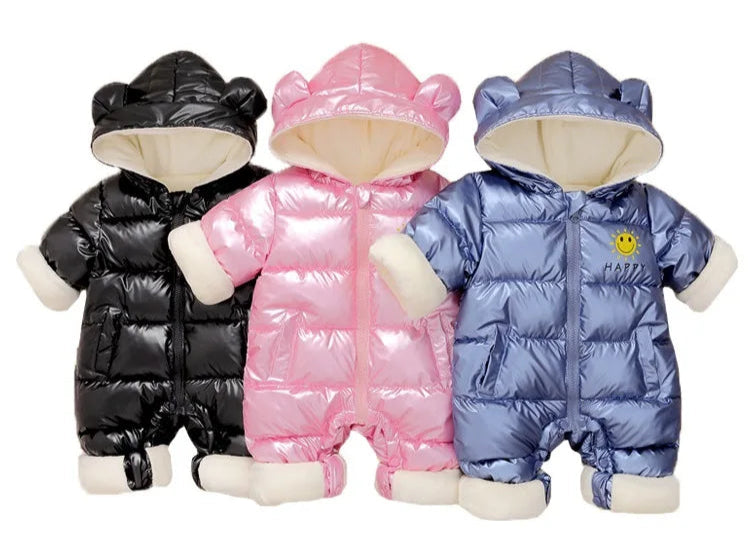 Three children's puffer snowsuits in black, pink, and blue on a white background.