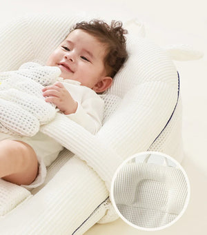 Child lying on a white mattress with a close-up of the mattress surface.
