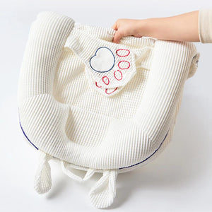 White textured bag with heart design held by a hand on a light gray background