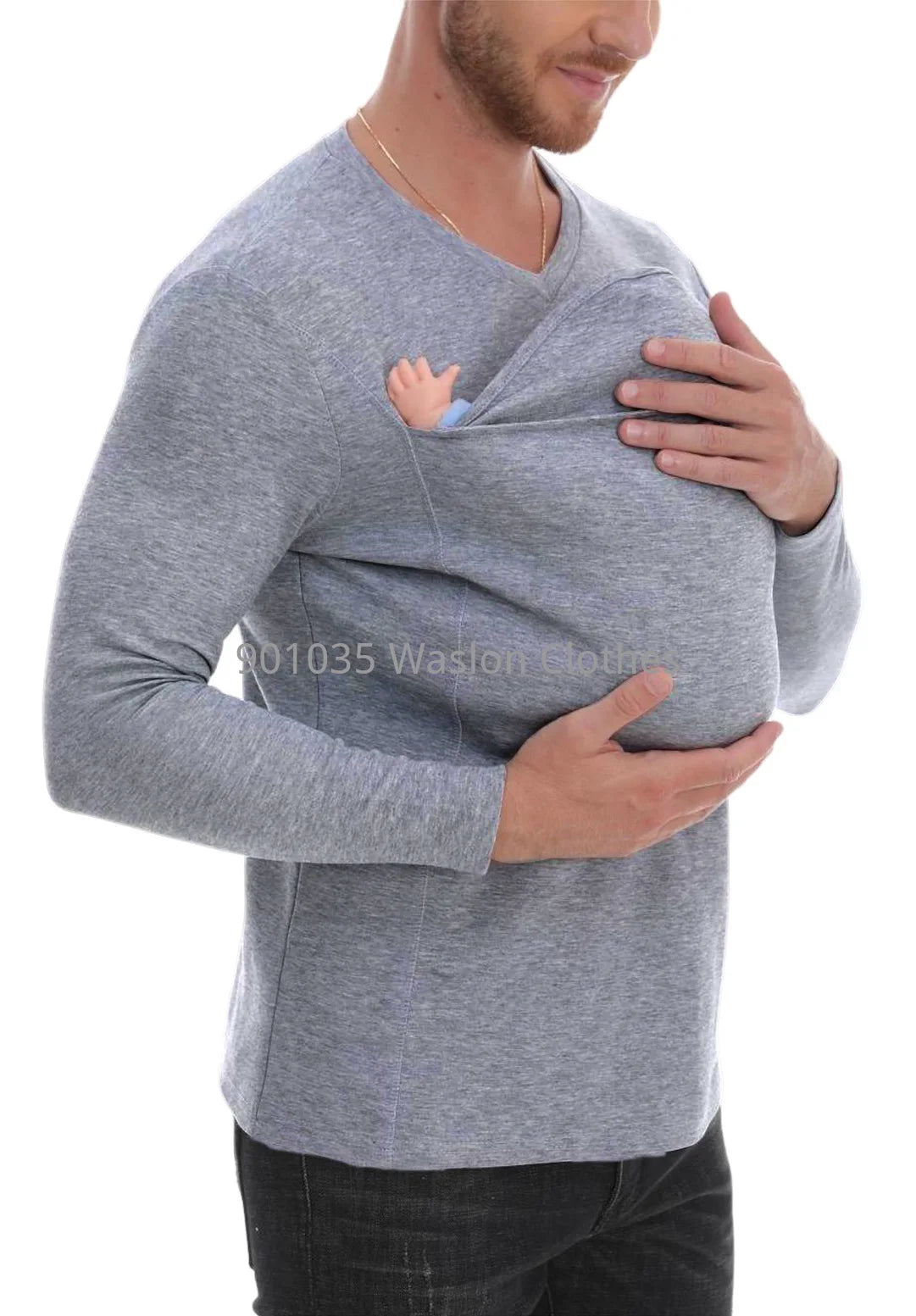 A man wearing a black long-sleeved baby carrier shirt with a baby in it, designed for hands-free bonding.