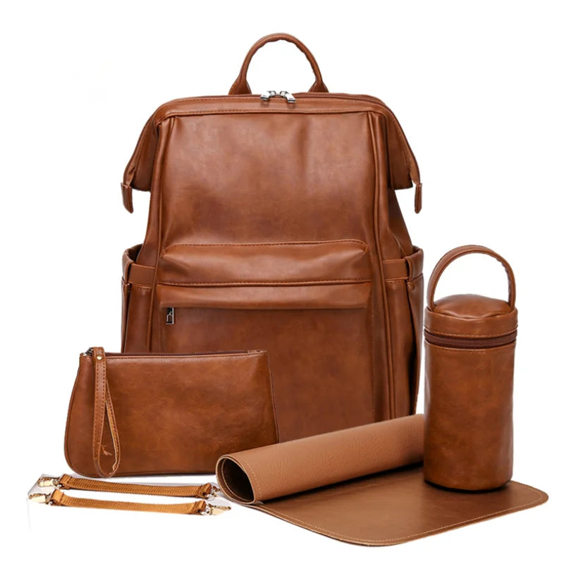 A vegan leather large capacity diaper bag backpack displayed with its components including a backpack, a changing pad, a small diaper bag, and stroller hooks. All items are brown in color.
