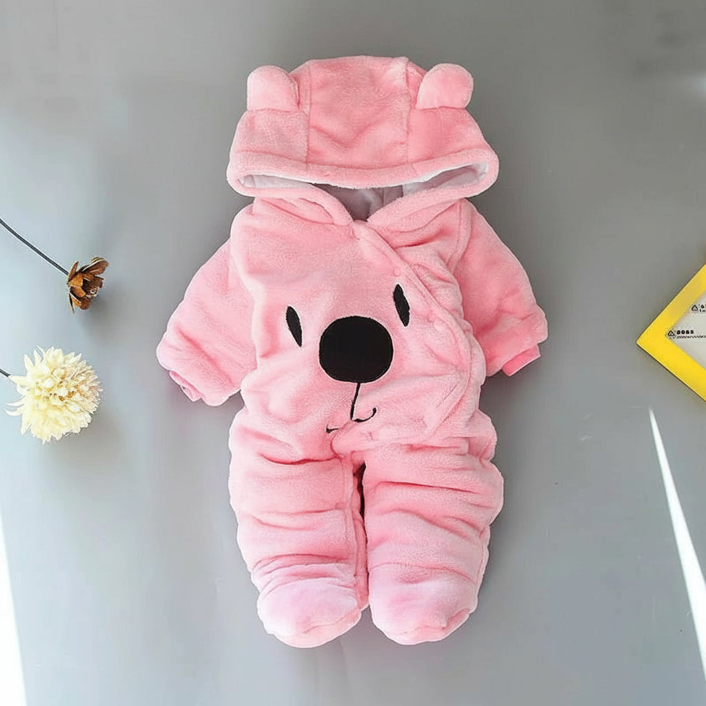 A beige Disney Winnie-the-Pooh winter jumpsuit for babies, featuring a hood with ears, footed design, and a smiling Winnie-the-Pooh face on the front.