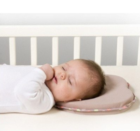 A collage of four images showing a heart-shaped newborn baby anti-flat head and positioning pillow. The top left image displays the pillow with decorative patterns.