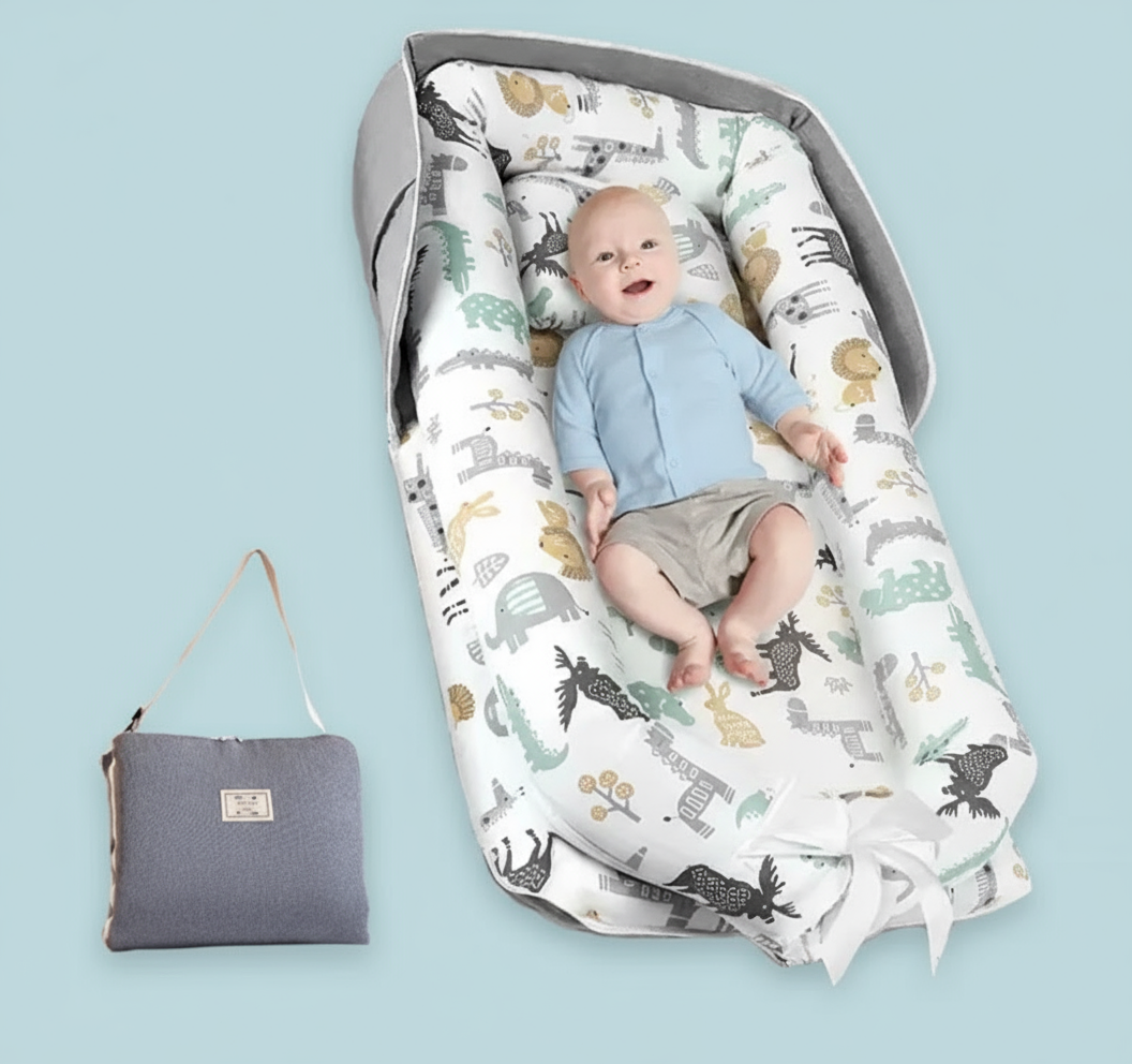Baby in a patterned baby bouncer with a matching bag on a white background