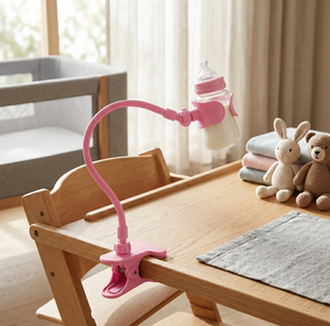Pink lamp with a bottle attachment on a wooden table in a room with a crib and toys.